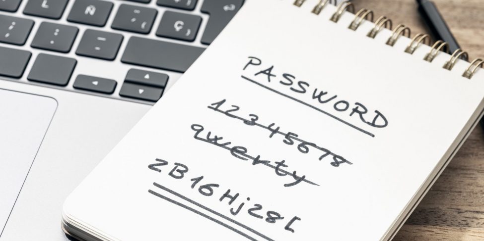 Strong and weak easy Password concept. Handwritten text on notepad on laptop