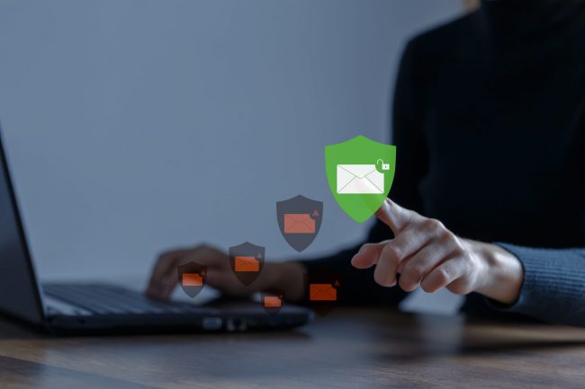 Business woman using computer to access email with anti-spam e-m